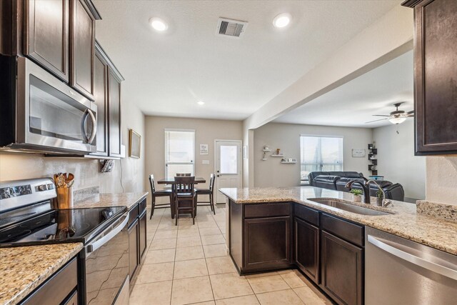 kitchen with sink, ceiling fan, a wealth of natural light, and appliances with stainless steel finishes