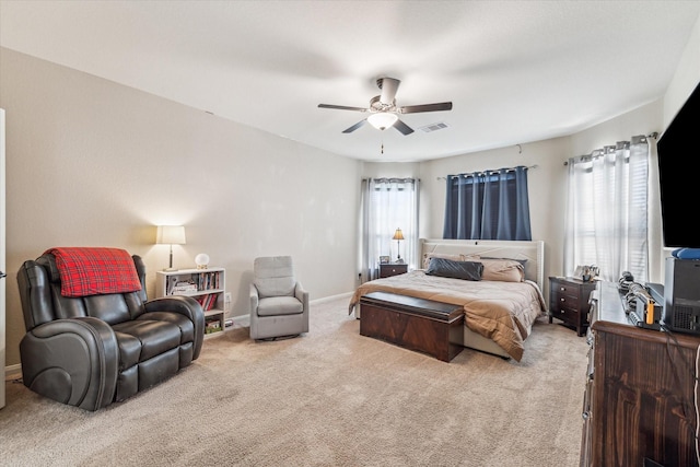 carpeted bedroom featuring ceiling fan and multiple windows