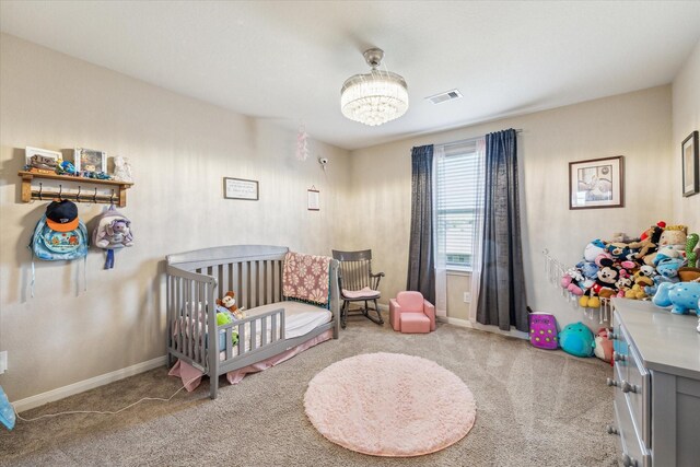 carpeted bedroom with a nursery area