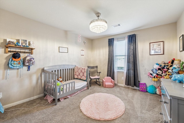 carpeted bedroom featuring a crib