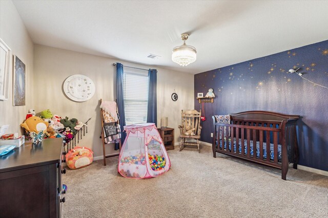 carpeted bedroom featuring a crib