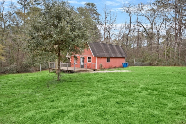 view of yard featuring a wooden deck and an outdoor structure