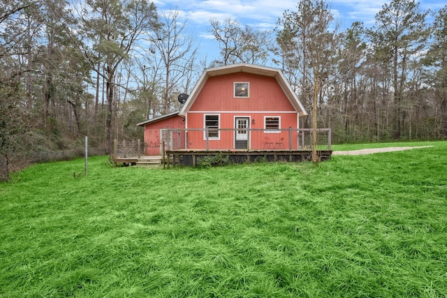 back of property featuring a deck and a yard