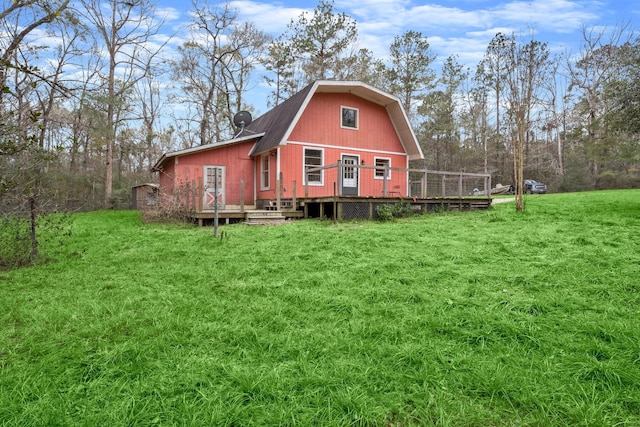 back of house with a wooden deck and a yard