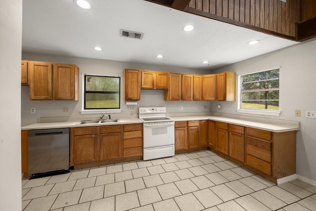 kitchen with stainless steel dishwasher, white range with electric cooktop, sink, and light tile patterned floors