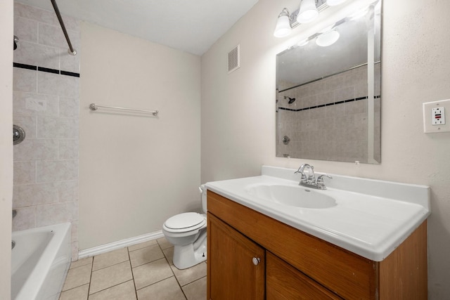 full bathroom with tiled shower / bath combo, tile patterned floors, vanity, and toilet