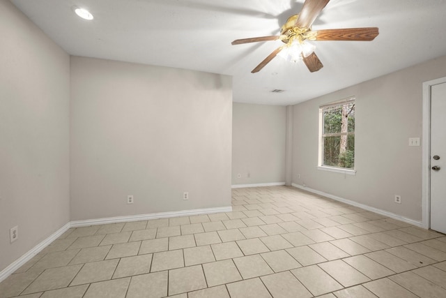 tiled spare room featuring ceiling fan