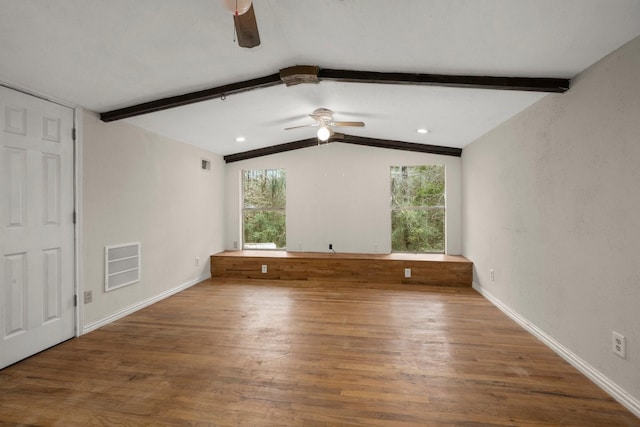 unfurnished bedroom with ceiling fan, lofted ceiling with beams, and wood-type flooring