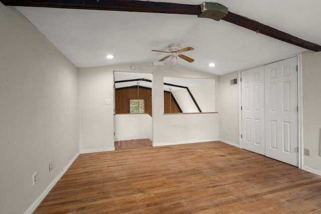 interior space with ceiling fan, wood-type flooring, and vaulted ceiling with beams