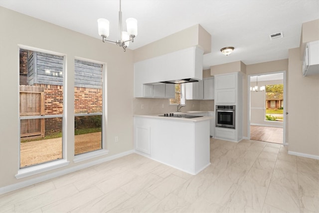 kitchen with stainless steel oven, a notable chandelier, white cabinetry, and kitchen peninsula