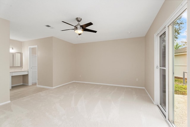 spare room featuring ceiling fan and light colored carpet