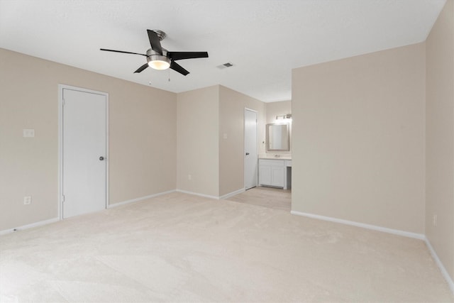 unfurnished room with ceiling fan and light carpet