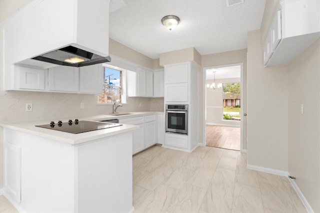 kitchen featuring stainless steel oven, custom range hood, black electric cooktop, sink, and white cabinetry