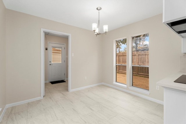 unfurnished dining area featuring an inviting chandelier