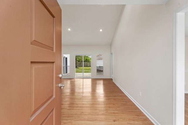 hallway with light hardwood / wood-style floors