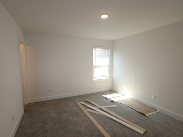 carpeted empty room with baseboards