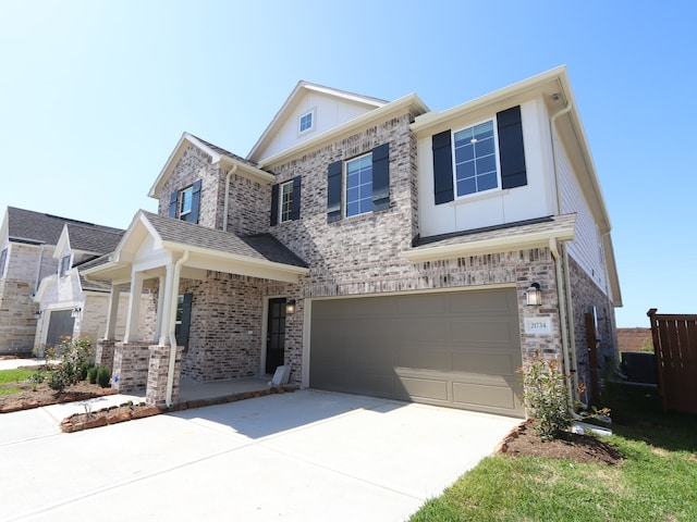 traditional-style home featuring concrete driveway, an attached garage, and brick siding