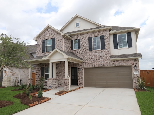21734 Persian Lake Dr, Cypress, TX 77433 - view of front of property with driveway, an attached garage, a shingled roof, covered porch, and brick siding