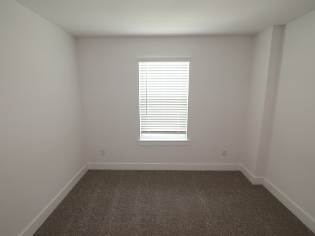 21734 Persian Lake Dr, Cypress, TX 77433 - empty room with dark carpet, healthy amount of natural light, and baseboards
