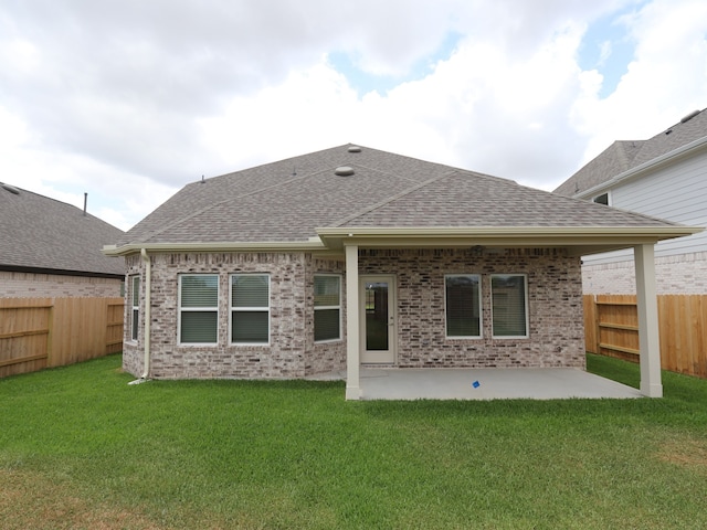 21734 Persian Lake Dr, Cypress, TX 77433 - back of property featuring a shingled roof, a patio area, and brick siding