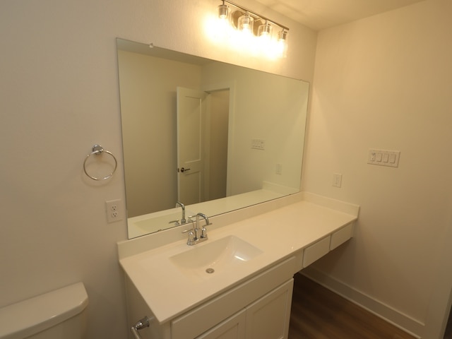21734 Persian Lake Dr, Cypress, TX 77433 - bathroom with vanity, wood finished floors, baseboards, and toilet