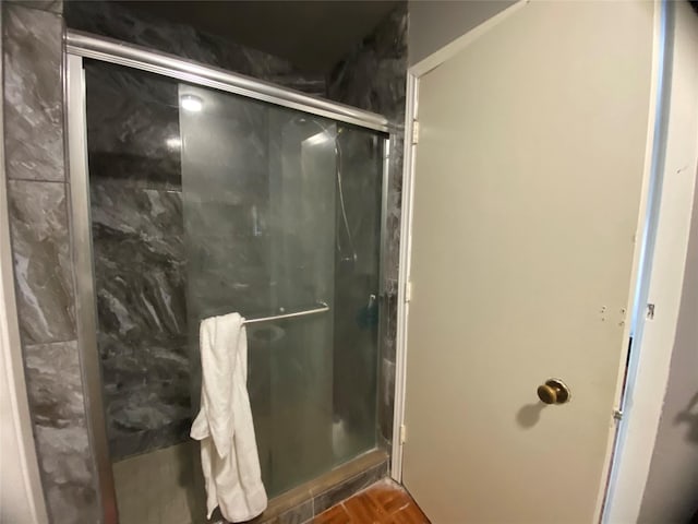 bathroom with a shower with shower door