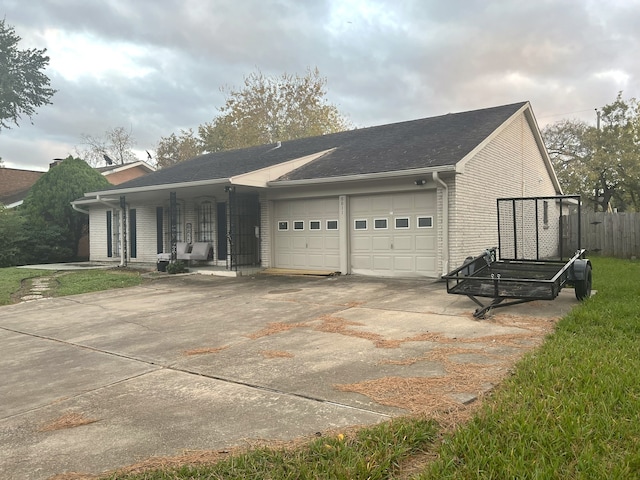 view of side of home featuring covered porch and a garage