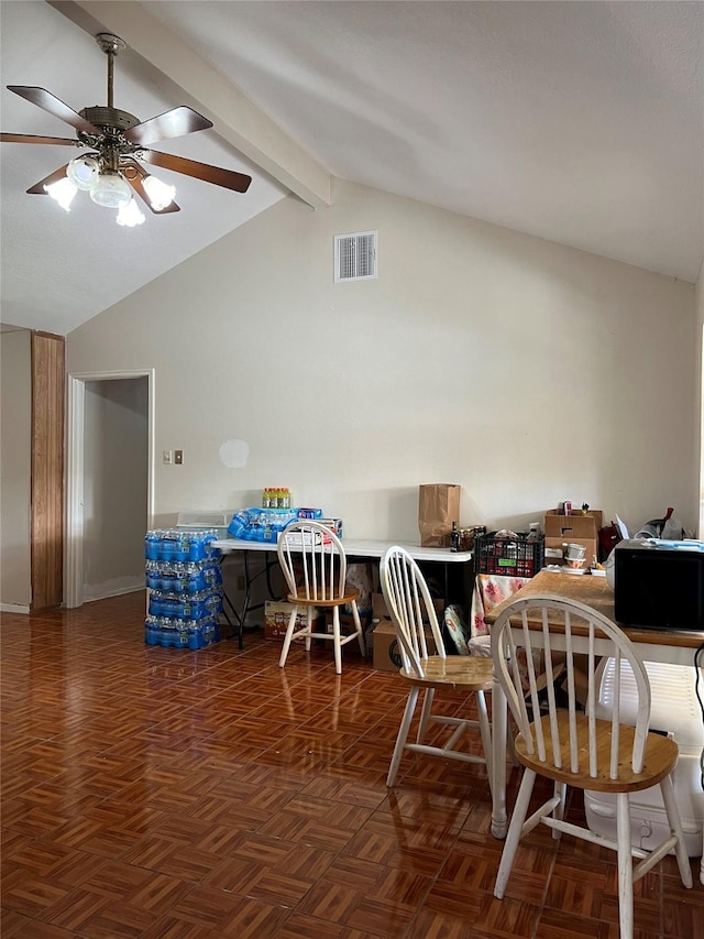 dining area with dark parquet flooring, ceiling fan, and vaulted ceiling with beams