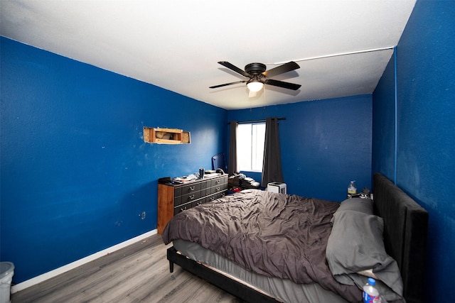 bedroom with ceiling fan and hardwood / wood-style floors