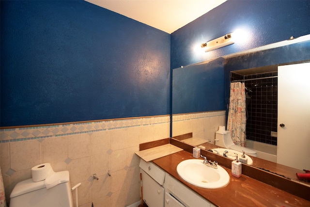 bathroom featuring toilet, tile walls, and vanity