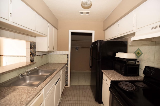 kitchen featuring white cabinets, black appliances, and sink