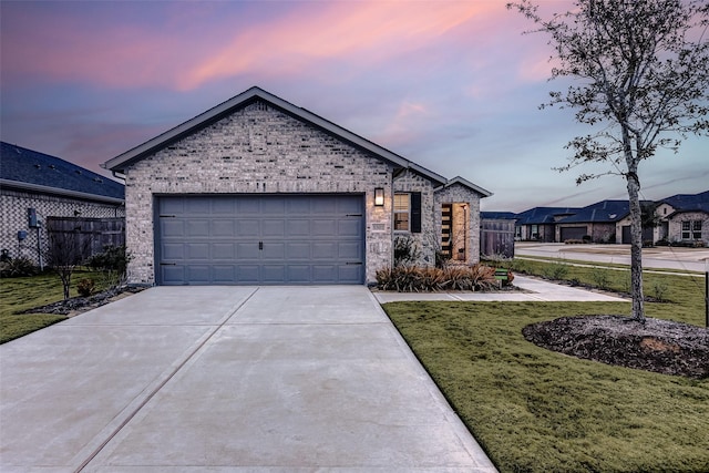 view of front facade featuring a garage and a yard