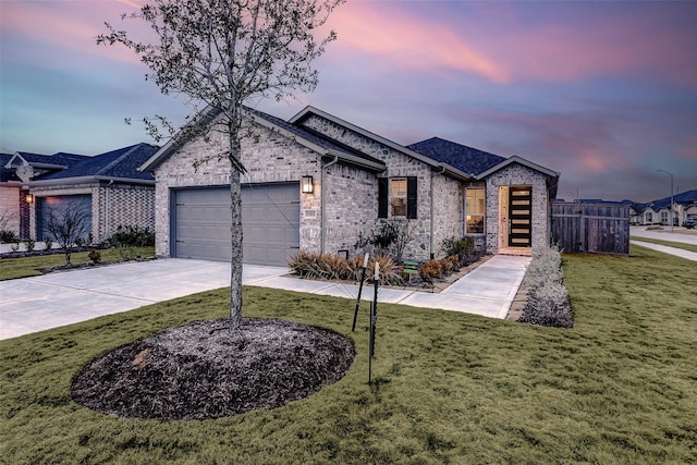 view of front of home featuring a garage and a lawn