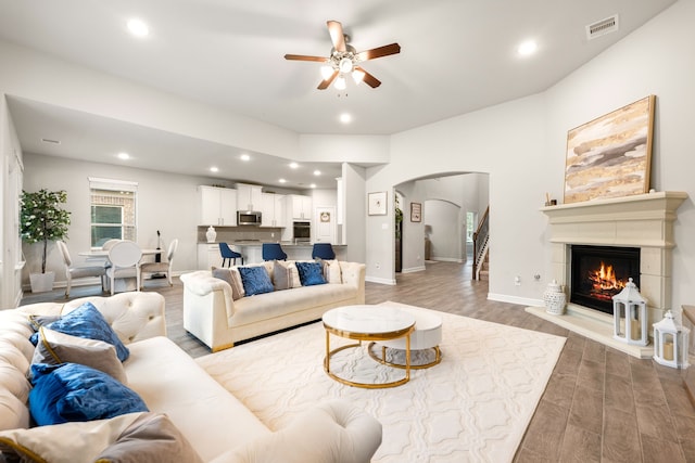 living room with ceiling fan and hardwood / wood-style floors