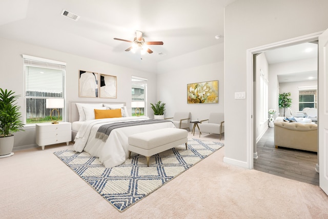 bedroom with ceiling fan and light colored carpet