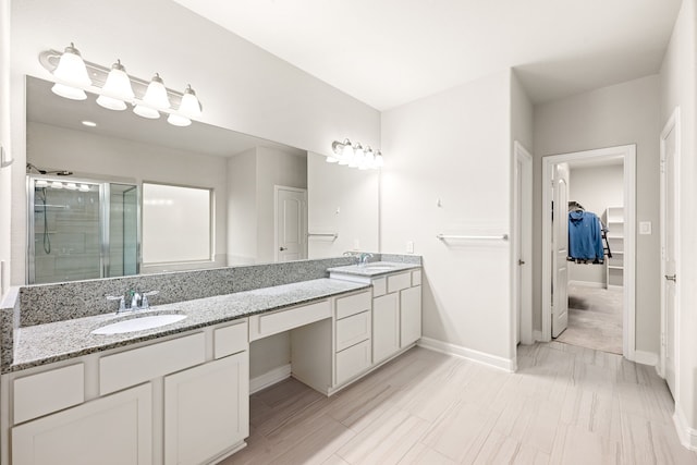 bathroom featuring an enclosed shower and vanity