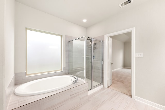 bathroom featuring shower with separate bathtub