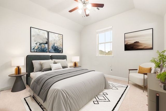 carpeted bedroom with ceiling fan and vaulted ceiling