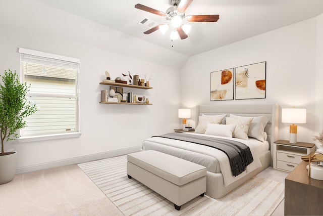 bedroom with lofted ceiling, ceiling fan, and light colored carpet