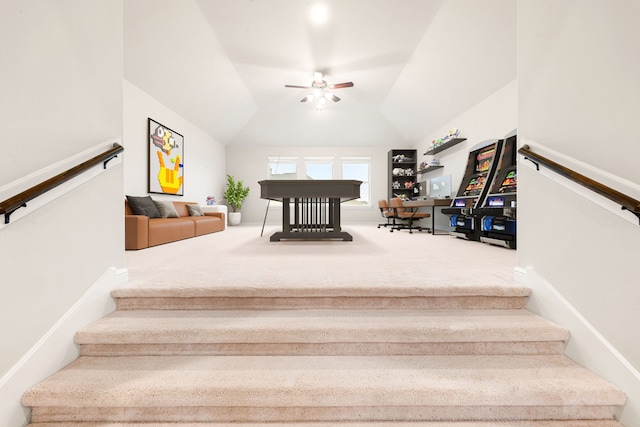 stairs with carpet floors, ceiling fan, and vaulted ceiling