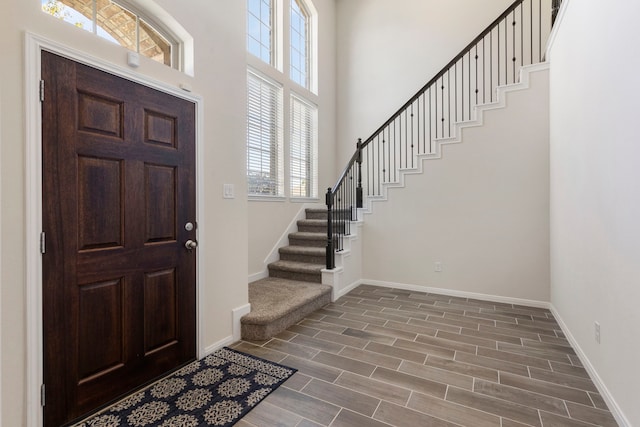 foyer entrance featuring a high ceiling and dark hardwood / wood-style floors