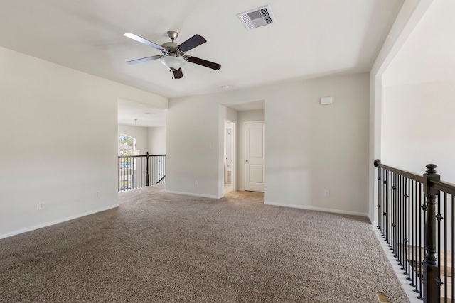 carpeted spare room with ceiling fan with notable chandelier