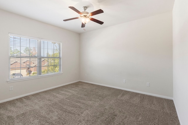 carpeted spare room with ceiling fan