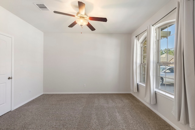 spare room with ceiling fan and carpet