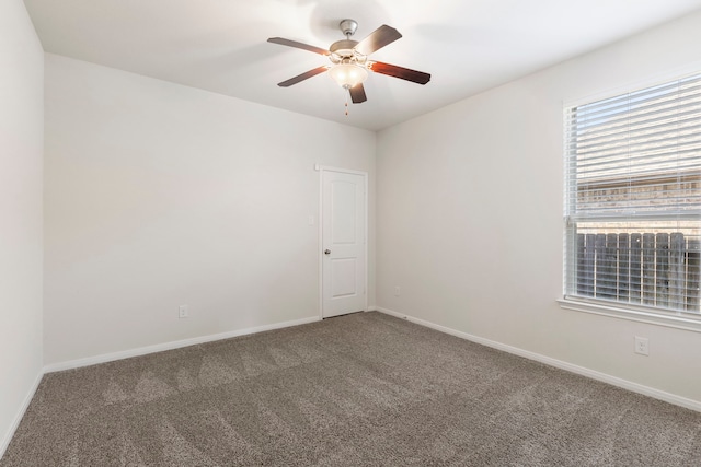 unfurnished room with ceiling fan and carpet