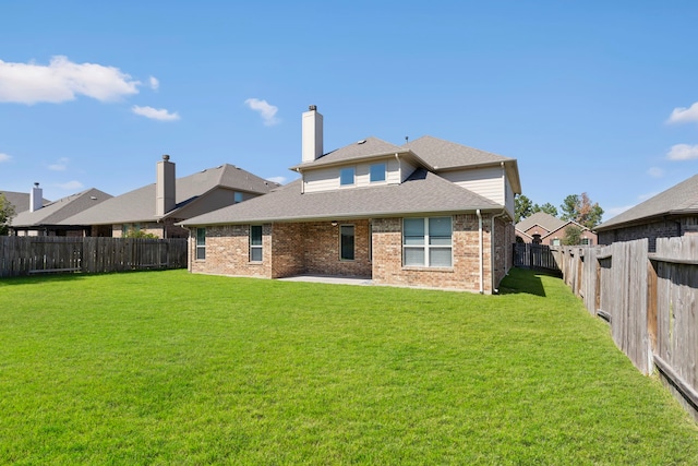 rear view of property with a patio area and a lawn