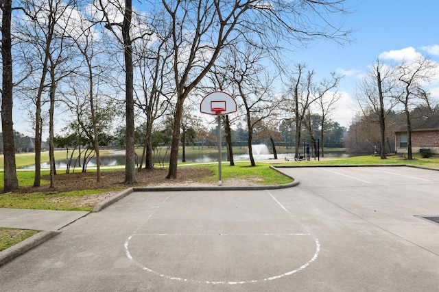 view of basketball court featuring a water view