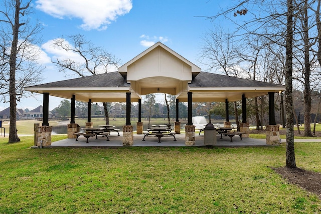 view of property's community featuring a patio area, a gazebo, and a lawn