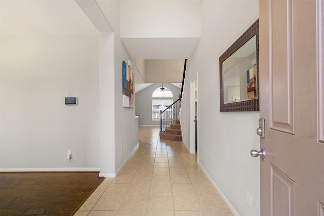 hall with light tile patterned floors