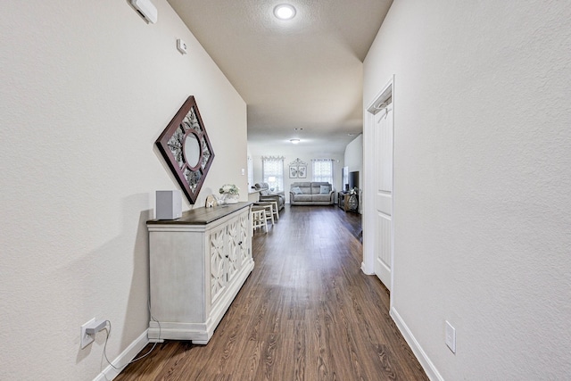 corridor with dark hardwood / wood-style flooring